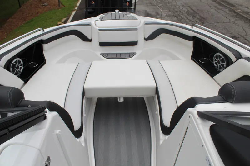 Slide: The Image of 2019 Yamaha Boats 242 Limited S interior with white seating and speakers. - 10