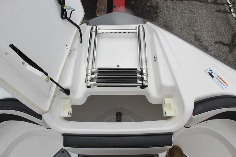Slide: The Image of 2019 Yamaha Boats 242 Limited S ladder compartment, open with stainless steel ladder. - 16