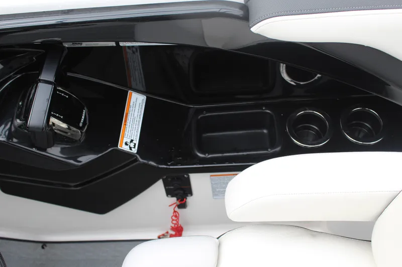 Slide: The Image of 2019 Yamaha Boats 242 Limited S cockpit with controls and cup holders. - 3