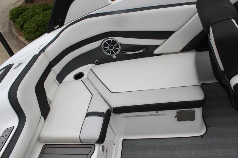 Slide: The Image of 2019 Yamaha Boats 242 Limited S interior seating with sleek white and black design. - 7