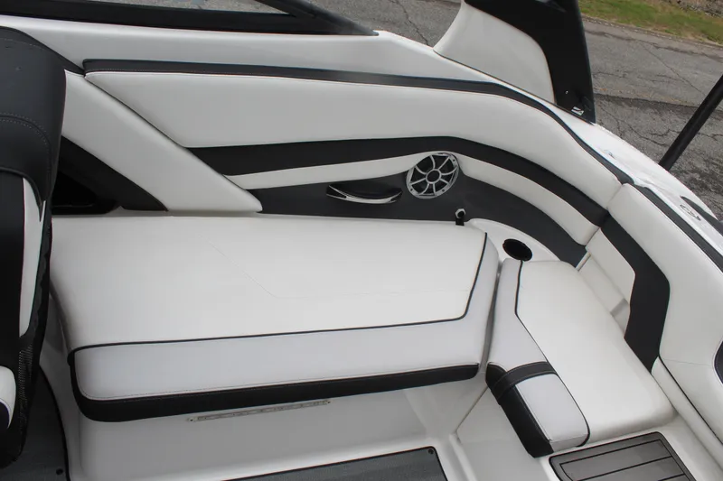 Slide: The Image of 2019 Yamaha Boats 242 Limited S interior seating with white and black upholstery. - 8