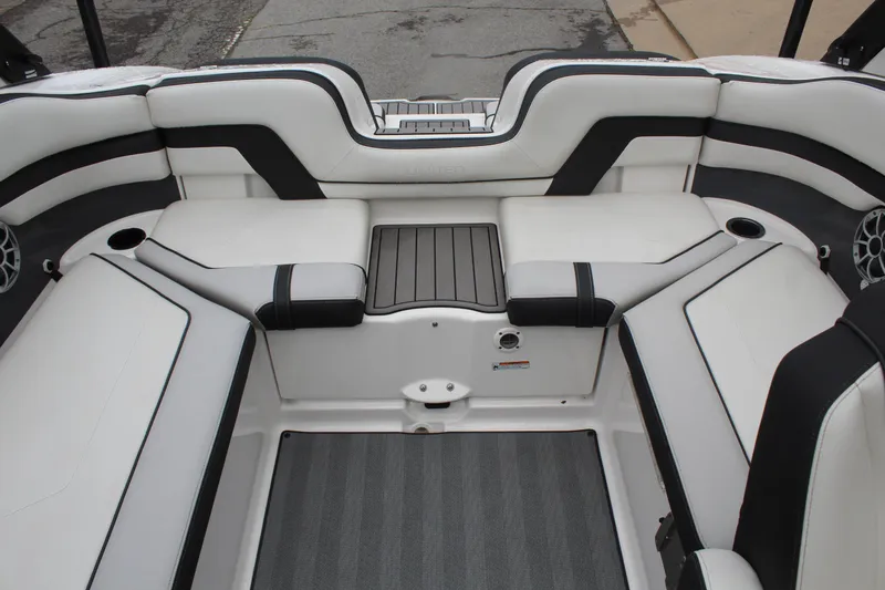 Slide: The Image of 2019 Yamaha Boats 242 Limited S interior with white and black seating and cup holders. - 9