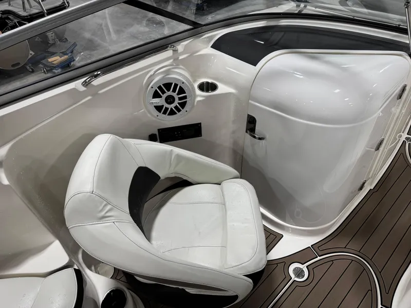 Slide: The Image of 2012 Larson LXi 288 boat interior with white seating and wood-style flooring. - 10