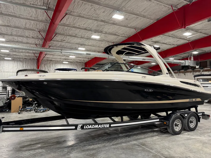 Slide: The Image of 2012 Sea Ray 250 SLX boat on Loadmaster trailer in indoor storage facility. - 1