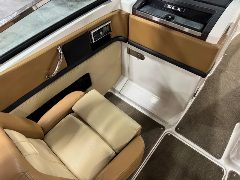 Slide: The Image of 2012 Sea Ray 250 SLX interior with tan leather seating and sleek design. - 10