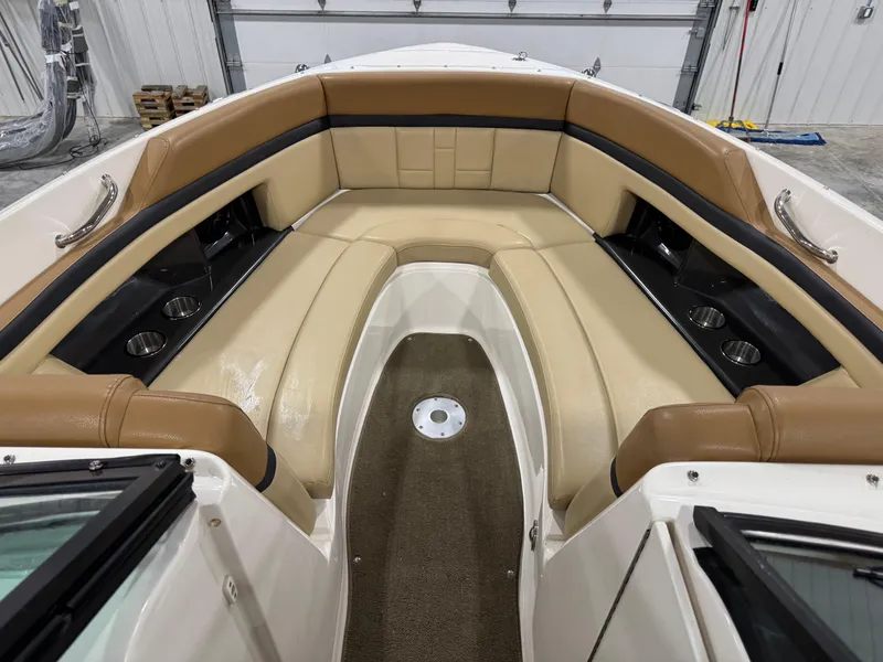 Slide: The Image of 2012 Sea Ray 250 SLX boat interior with tan leather seating and cup holders. - 11