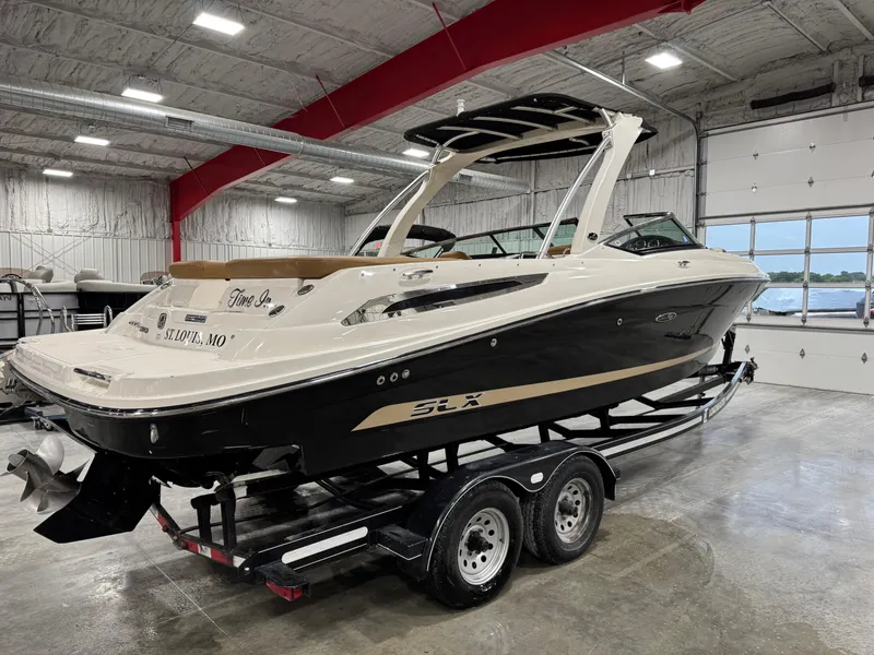 Slide: The Image of 2012 Sea Ray 250 SLX boat on trailer in indoor storage facility. - 3