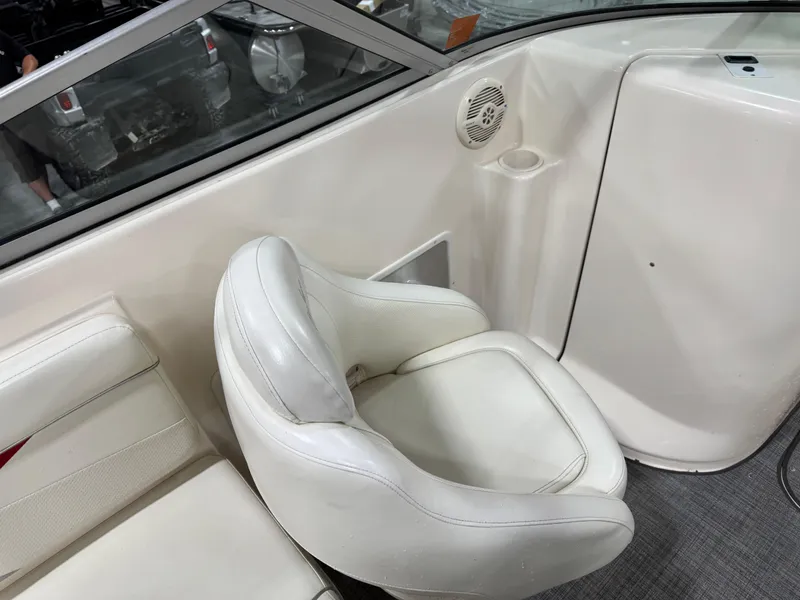 Slide: The Image of 2005 Rinker 282 BR boat interior with white seating and speaker. - 11