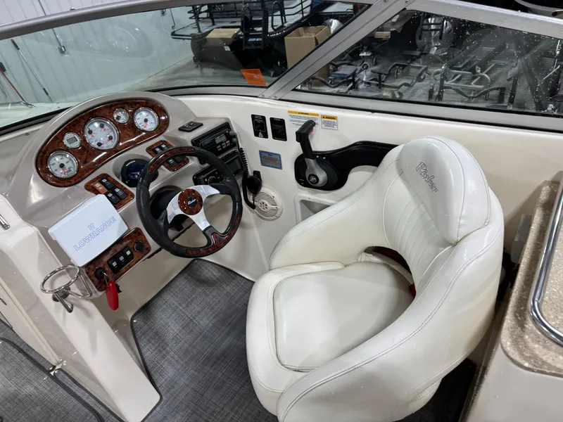 Slide: The Image of 2005 Rinker 282 BR boat cockpit with white leather seat and instrument panel. - 13