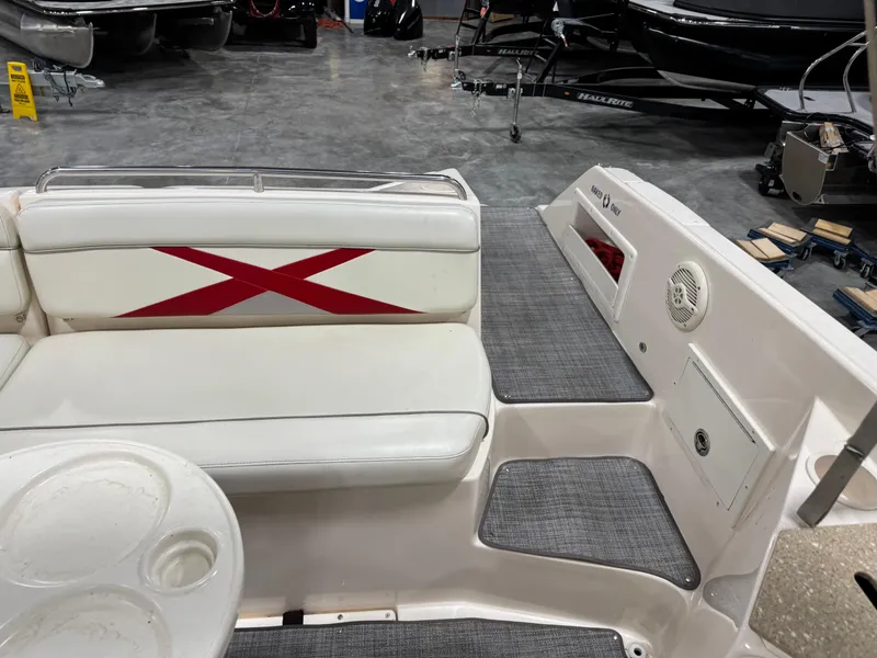 Slide: The Image of 2005 Rinker 282 BR boat interior with white seating and red accents. - 14