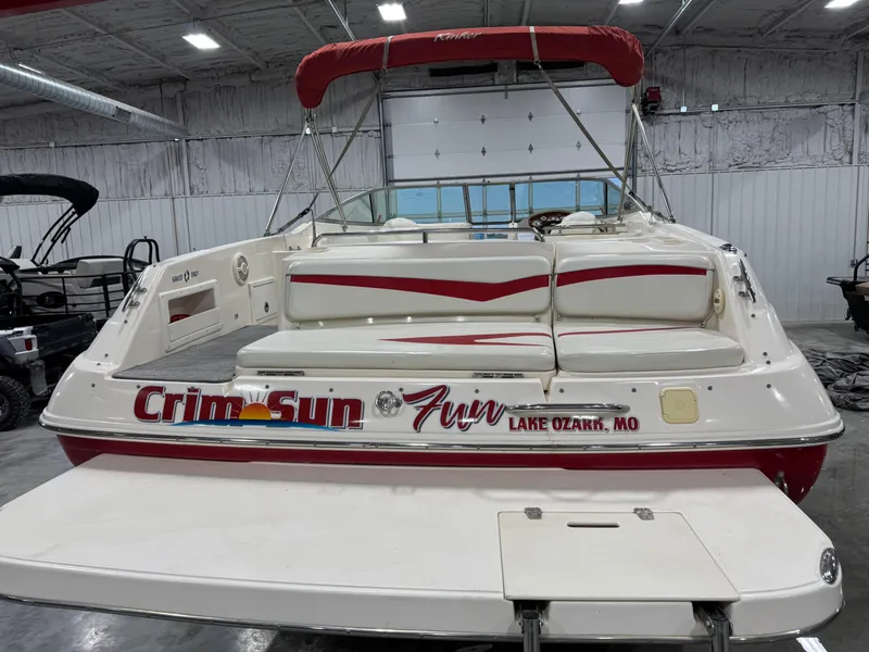 Slide: The Image of 2005 Rinker 282 BR boat with red accents, docked indoors, labeled "Crim-Sun Fun" Lake Ozark, MO. - 5
