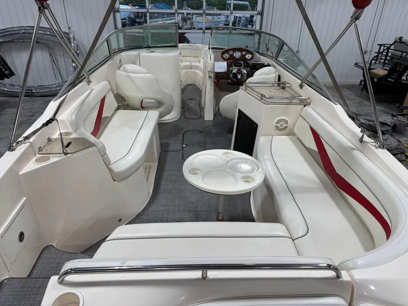 Slide: The Image of 2005 Rinker 282 BR boat interior with seating, table, and helm. - 7