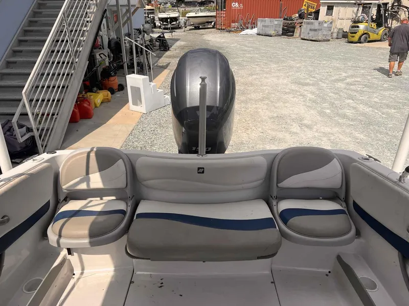 Slide: The Image of 2000 Four Winns 180 Horizon boat interior with seating and outboard motor in a marina setting. - 10