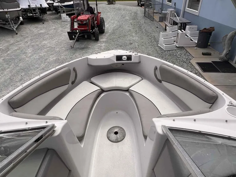 Slide: The Image of 2000 Four Winns 180 Horizon boat interior with cushioned seating and open bow design. - 6