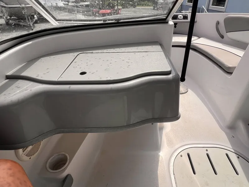 Slide: The Image of Interior of a 2000 Four Winns 180 Horizon boat, featuring seating and storage areas. - 8