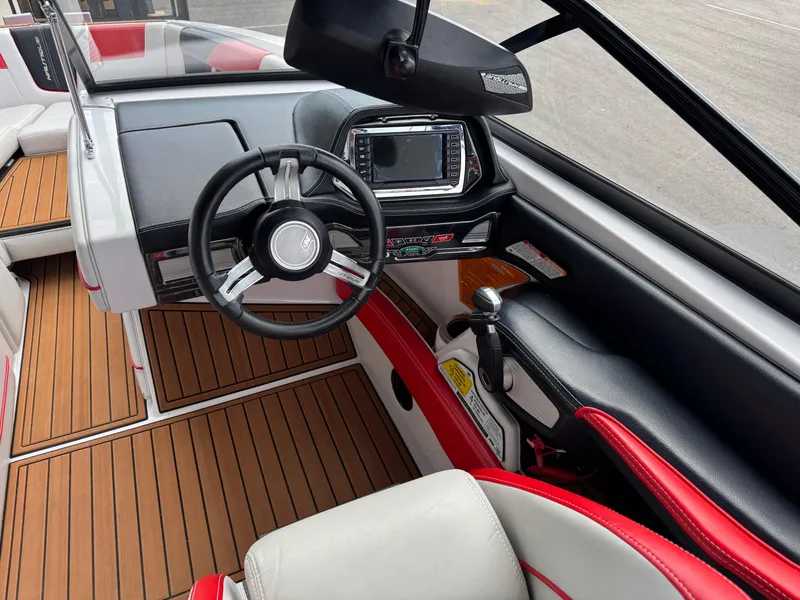 Slide: The Image of 2014 Correct Craft G23 boat interior with steering wheel and dashboard controls. - 11