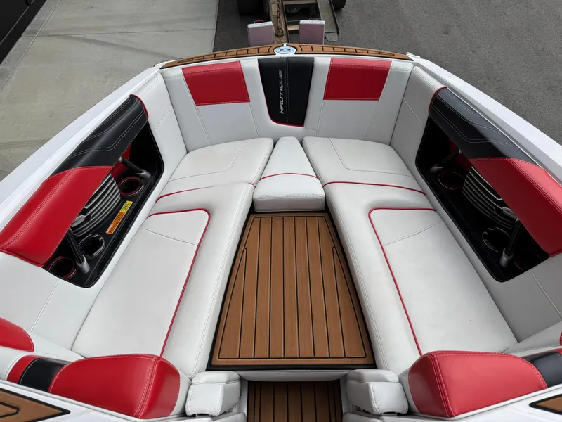 Slide: The Image of 2014 Correct Craft G23 boat interior with red and white seating, wood flooring. - 12
