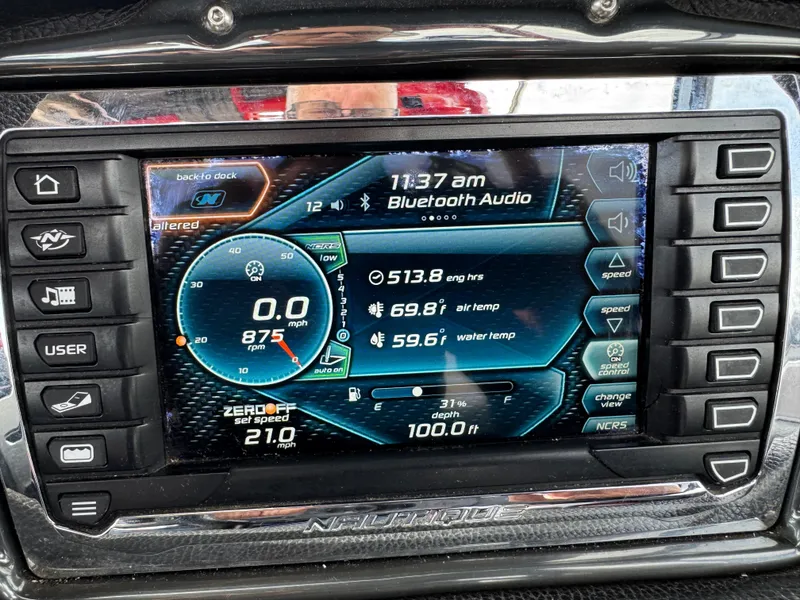Slide: The Image of Dashboard display of a 2014 Correct Craft G23 boat showing speed, RPM, and temperature. - 14