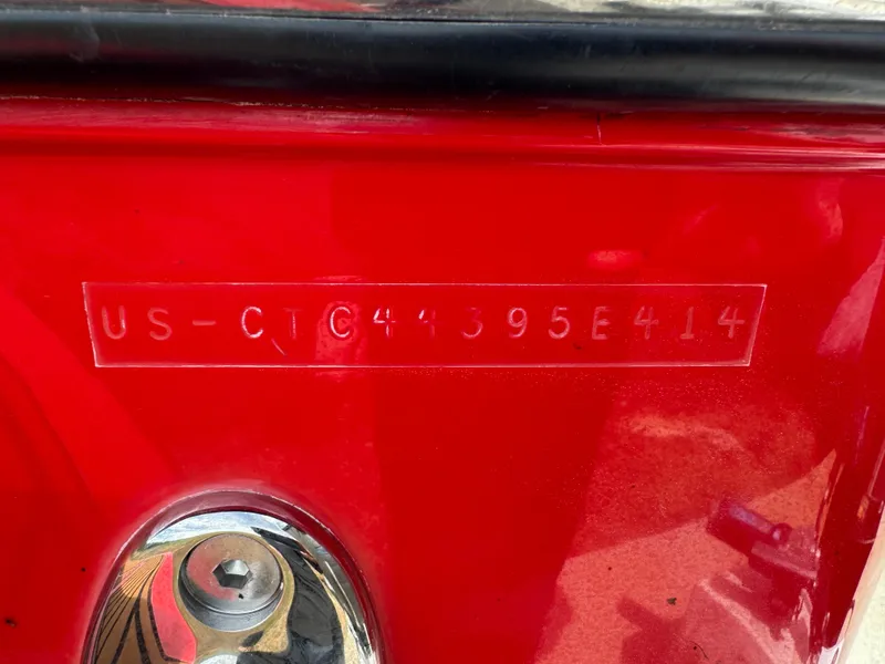 Slide: The Image of 2014 Correct Craft G23 boat hull identification number on red surface. - 16