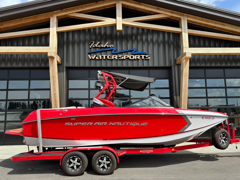 Slide: The Image of Red 2014 Correct Craft G23 boat on trailer at Idaho Water Sports facility. - 2