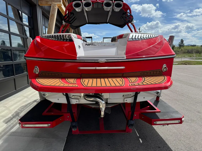 Slide: The Image of 2014 Correct Craft G23 boat, red exterior, rear view with teak swim platform. - 4