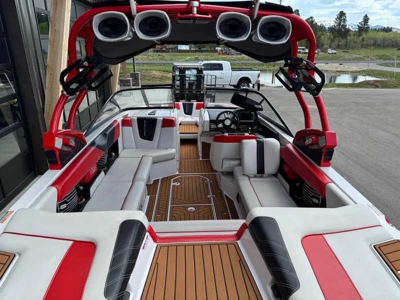 Slide: The Image of 2014 Correct Craft G23 boat interior with red accents and spacious seating. - 8