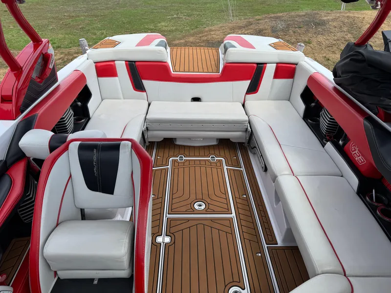 Slide: The Image of 2014 Correct Craft G23 boat interior with white and red seating, teak flooring. - 9