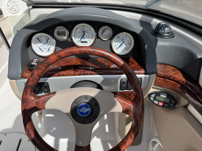 Slide: The Image of 2006 Four Winns Horizon dashboard with wood accents and steering wheel. - 10