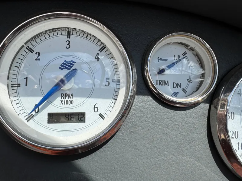 Slide: The Image of Close-up of 2006 Four Winns Horizon boat gauges, showing RPM and trim indicators. - 11