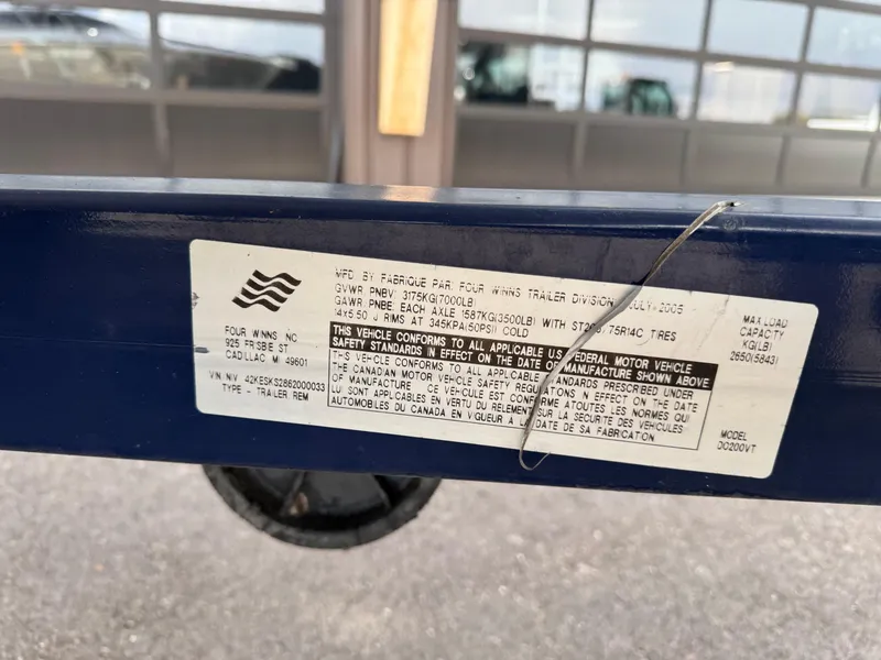 Slide: The Image of Label on a 2006 Four Winns Horizon trailer, displaying safety and manufacturing details. - 13