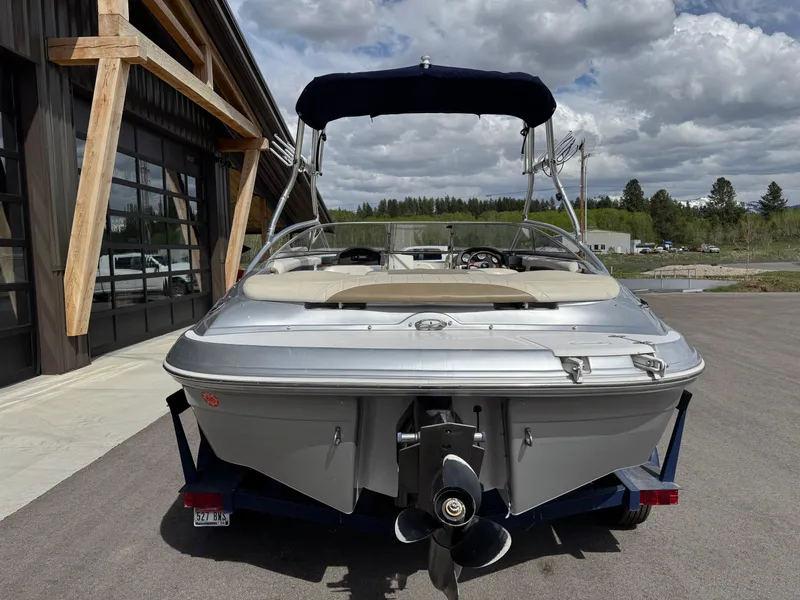 Slide: The Image of 2006 Four Winns Horizon boat with canopy, parked outdoors on a trailer. - 5