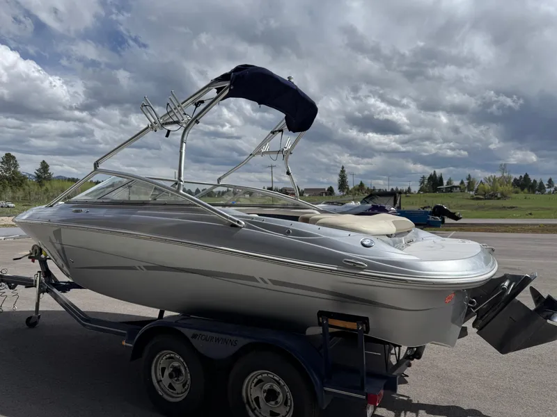 Slide: The Image of 2006 Four Winns Horizon boat on trailer under cloudy sky. - 6