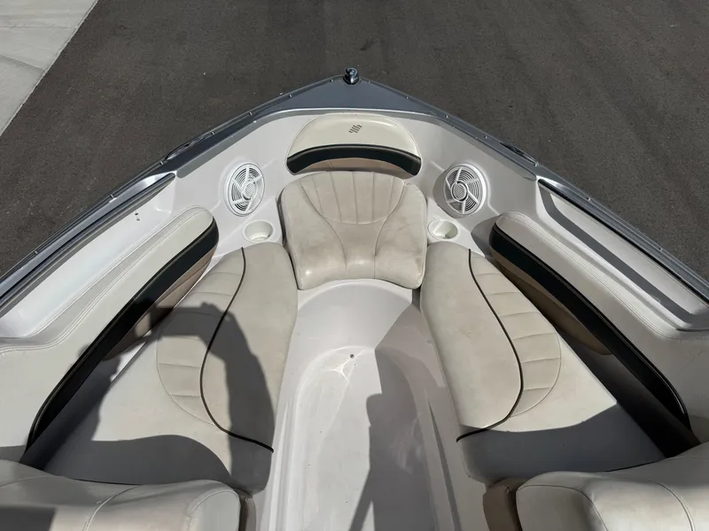 Slide: The Image of 2006 Four Winns Horizon boat interior with beige seating and cup holders. - 8