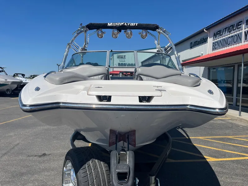 Slide: The Image of 2008 MasterCraft X35 boat on trailer, parked outside dealership under clear blue sky. - 11