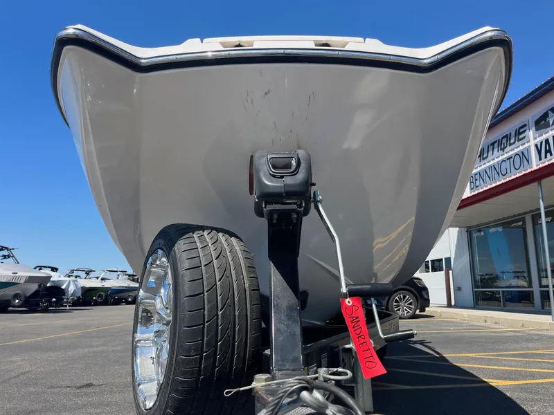 Slide: The Image of 2008 MasterCraft X35 boat on trailer at dealership, showcasing hull and wheel detail. - 12