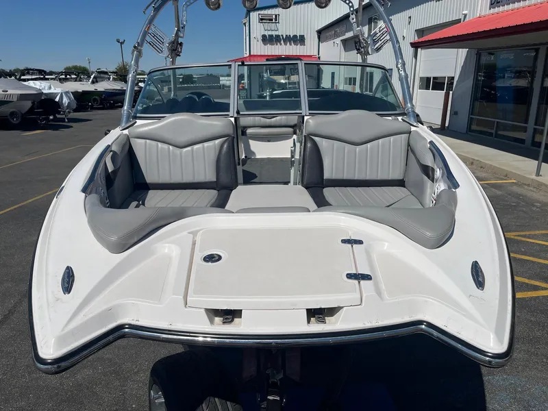 Slide: The Image of 2008 MasterCraft X35 boat with gray seating, parked outside a service center. - 13