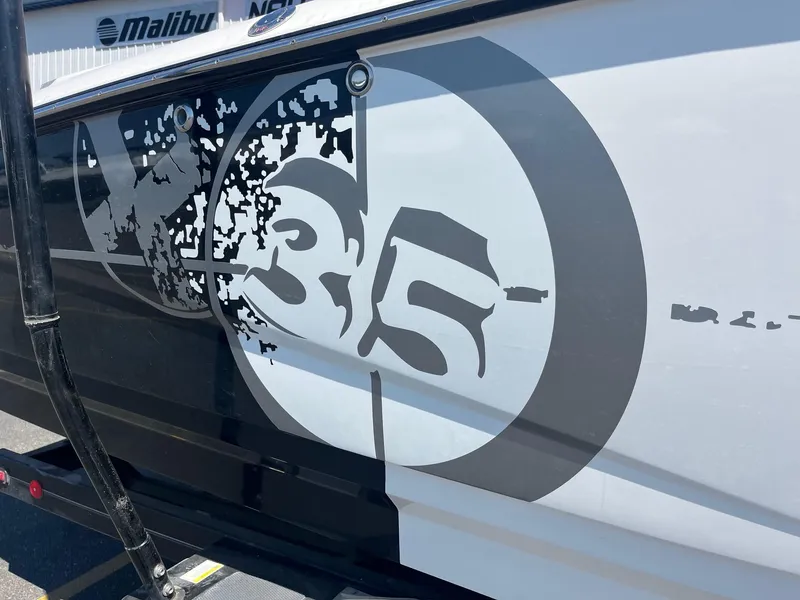 Slide: The Image of 2008 MasterCraft X35 boat with distinctive black and white graphics on the side. - 16