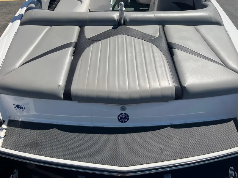 Slide: The Image of 2008 MasterCraft X35 boat with gray cushioned seating and Swell Wakesurf branding. - 17