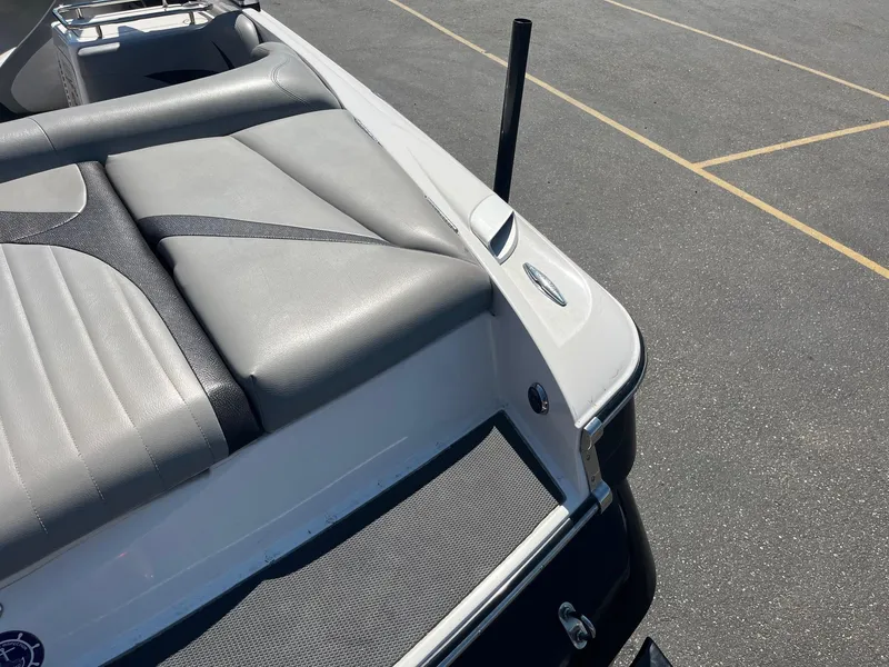 Slide: The Image of 2008 MasterCraft X35 boat with gray seating and sleek design in a parking lot. - 18