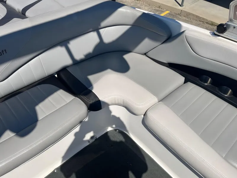 Slide: The Image of 2008 MasterCraft X35 boat interior with gray seating and cup holders. - 24