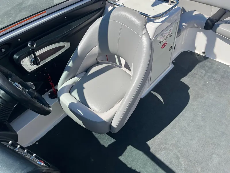 Slide: The Image of 2008 MasterCraft X35 boat interior with gray captain's seat and control panel. - 28