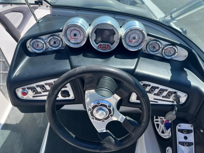 Slide: The Image of Dashboard of a 2008 MasterCraft X35 boat with gauges and steering wheel. - 29