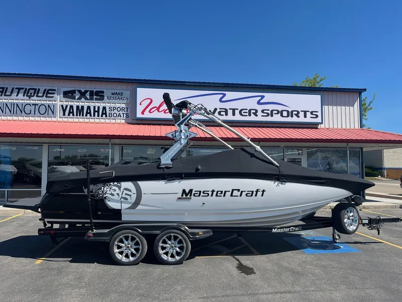 Slide: The Image of 2008 MasterCraft X35 boat on trailer at dealership, under clear blue sky. - 3
