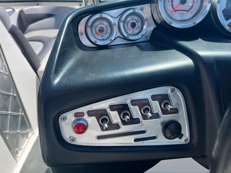 Slide: The Image of Dashboard controls of a 2008 MasterCraft X35 boat, featuring gauges and switches. - 30