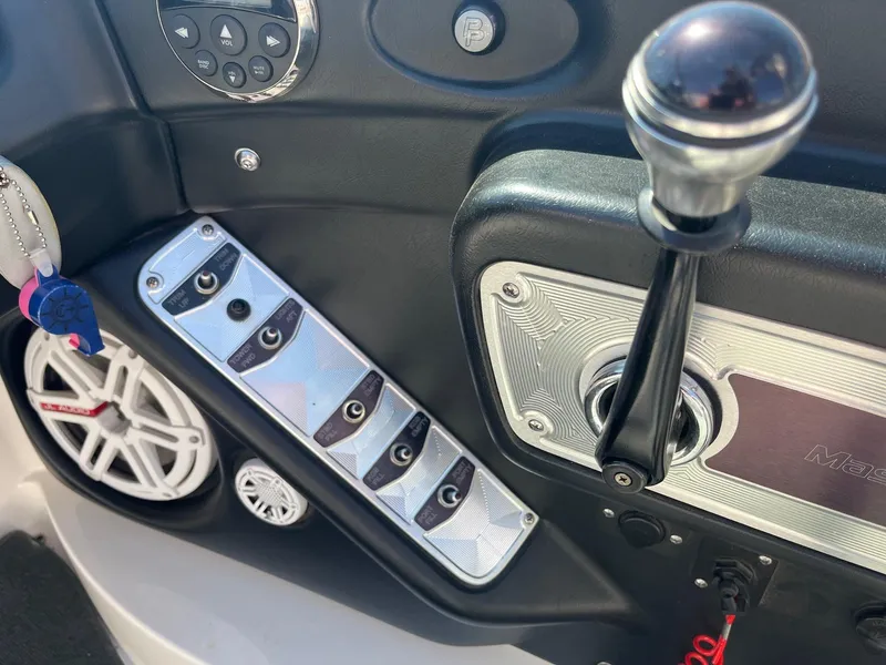 Slide: The Image of 2008 MasterCraft X35 boat dashboard with controls and speaker. - 32