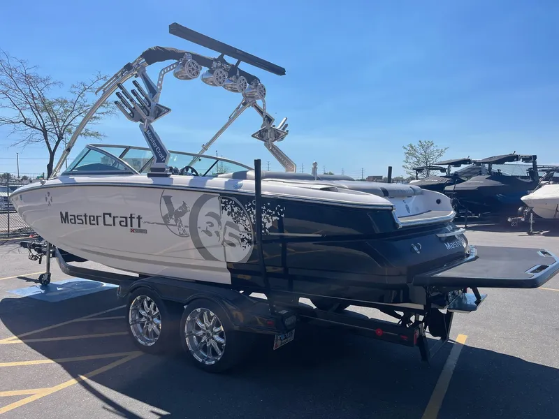 Slide: The Image of 2008 MasterCraft X35 boat on trailer under clear blue sky. - 8