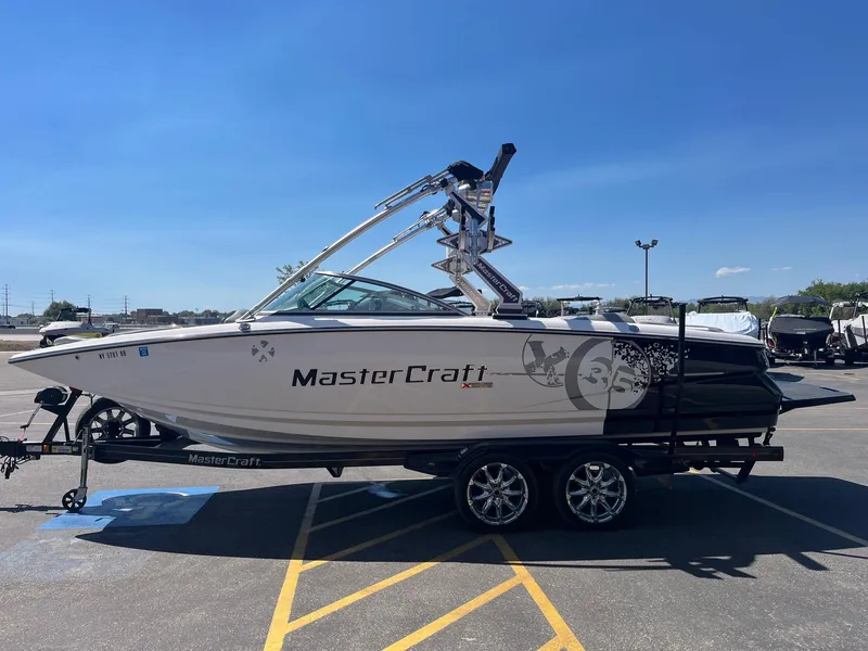 Slide: The Image of 2008 MasterCraft X35 boat on trailer under clear blue sky. - 9