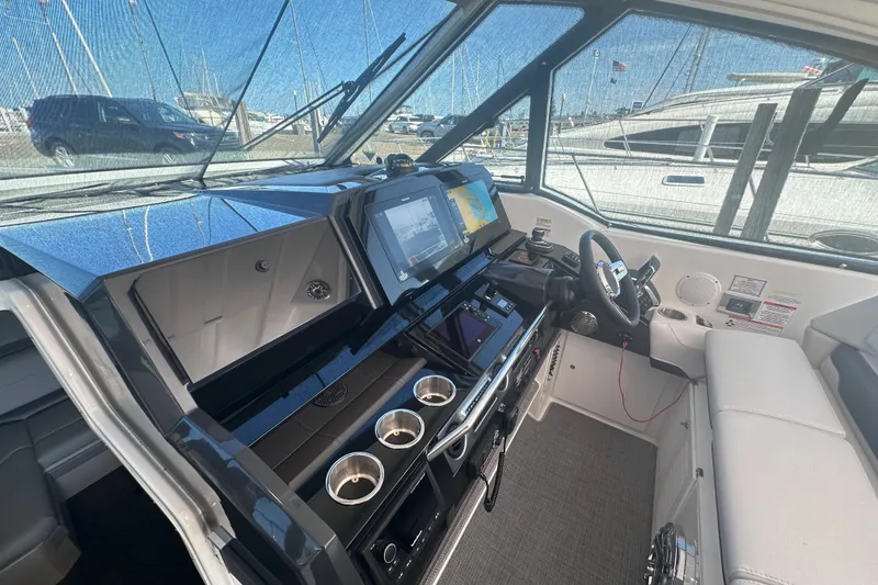 Slide: The Image of 2023 Formula 380 Super Sport Crossover OB cockpit with modern navigation system and luxurious seating. - 14