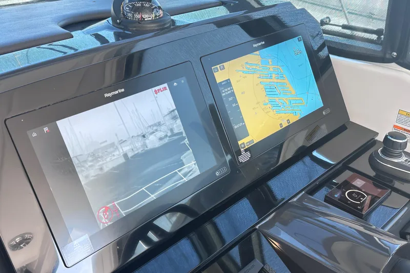Slide: The Image of 2023 Formula 380 Super Sport Crossover OB dashboard with dual Raymarine displays. - 15