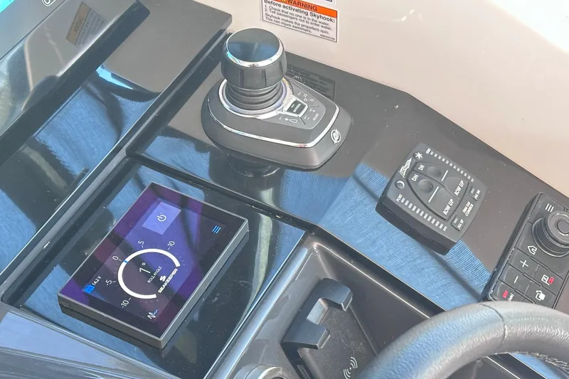 Slide: The Image of 2023 Formula 380 Super Sport Crossover OB dashboard with control panel and joystick. - 16